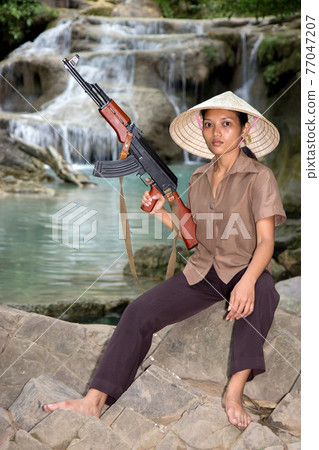 Asian woman armed Asian woman armed 77047207
