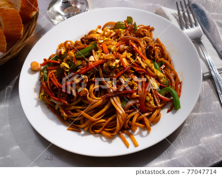 Stir fried noodles soba with vegetables, chicken and omelette Stir fried noodles soba with vegetables, chicken and omelette 77047714