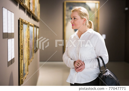 Closeup on mature female visiting museum 77047771