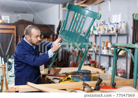 Carpenter repairing antique chair Carpenter repairing antique chair 77047869