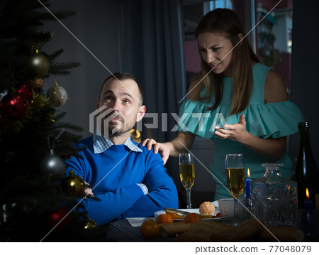 Pair arguing at Christmas night Pair arguing at Christmas night 77048079