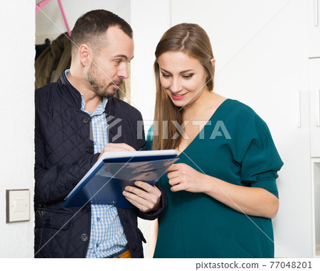 Caseworker helping woman polling questionnaire Caseworker helping woman polling questionnaire 77048201
