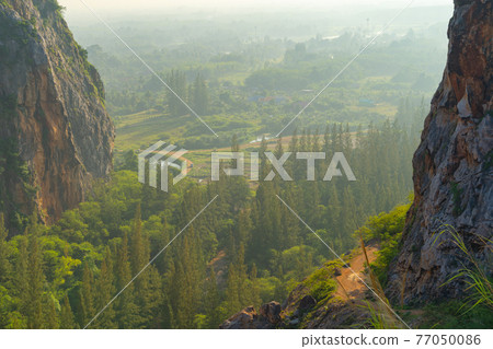 Khao Kuha at Songkhla. Mountain hill with green forest trees. Nature landscape background in Thailand. Huangshan mountain. Khao Kuha at Songkhla. Mountain hill with green forest trees. Nature landscape background in Thailand. Huangshan mountain. 77050086