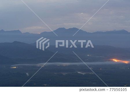 Aerial top view of forest trees with fog mist and green mountain hill at sunset. Nature landscape background, Thailand. Aerial top view of forest trees with fog mist and green mountain hill at sunset. Nature landscape background, Thailand. 77050105