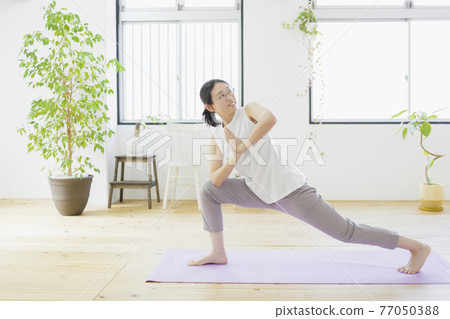Women doing yoga in the living room Fitness Beauty Women doing yoga in the living room Fitness Beauty 77050388