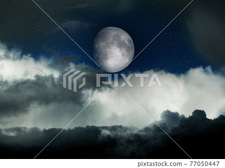 The moon in the night sky 77050447