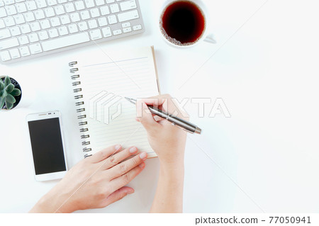 Businessman working in modern white office desk table with keyboard computer, notebook, tree, glasses and cup of coffee. Top view with copy space, Businessman working in modern white office desk table with keyboard computer, notebook, tree, glasses and cup of coffee. Top view with copy space, 77050941