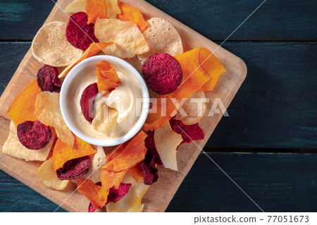 Vegetable chips with a homemade dip, overhead shot with a place for text 77051673