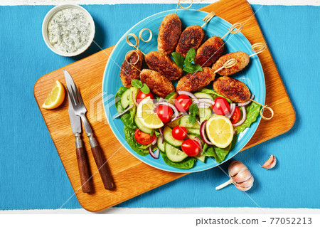 Lamb kofta kebabs with vegetables, top view 77052213