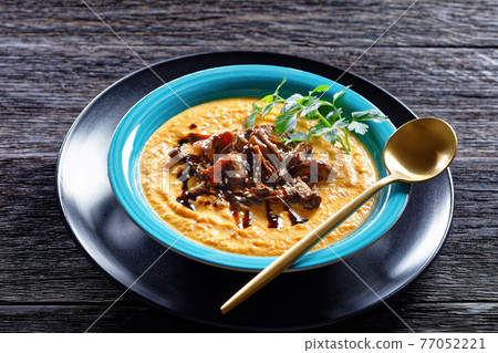 Pumpkin soup with wild mushrooms broth, top view 77052221