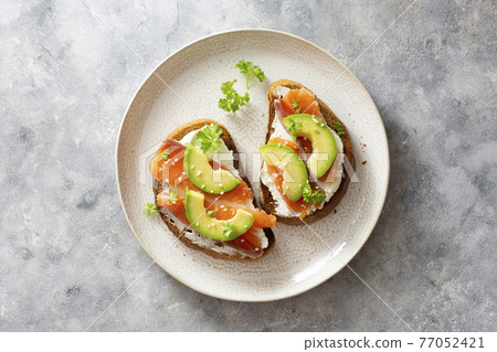 Healthy food, avocado and red fish salmon toast sandwich for breakfast or keto dieting 77052421