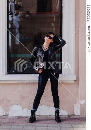 Fashion model in sunglasses and leather jacket Fashion model in sunglasses and leather jacket 77052971