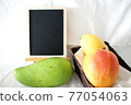Several types of mango and blackboard 77054063