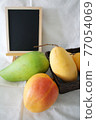 Several types of mango and blackboard 77054069