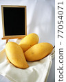 Yellow mango and blackboard 77054071