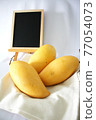 Yellow mango and blackboard 77054073