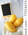 Yellow mango and blackboard 77054074