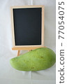 Green mango, decoration and blackboard 77054075
