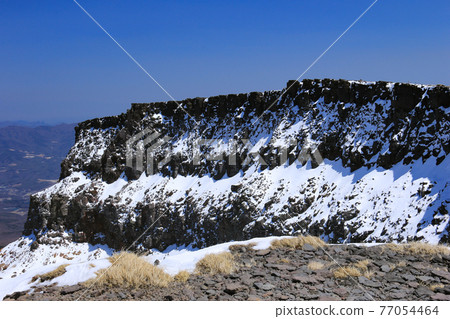 Crater wall at the top of Mt. Iodake, Yatsugatake mountain range with residual snow, Hokuto City, Yamanashi Prefecture, Japan 77054464