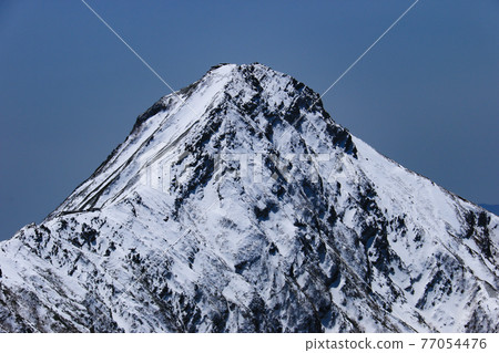 From the summit of Mt. Iodake, the Yatsugatake mountain range (Akadake) with the remaining snow, Hokuto City, Yamanashi Prefecture, Japan 77054476