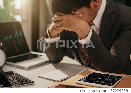 Portrait unhappy young business man worried and sad from business from COVID-19. 77054589
