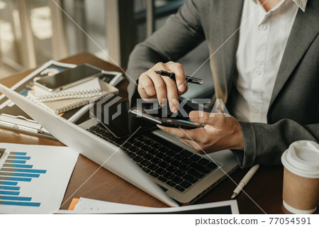 Businesswomen hand using smart phone, tablet payments online shopping, omni channel, digital tablet docking keyboard computer at office in sun light. Businesswomen hand using smart phone, tablet payments online shopping, omni channel, digital tablet docking keyboard computer at office in sun light. 77054591