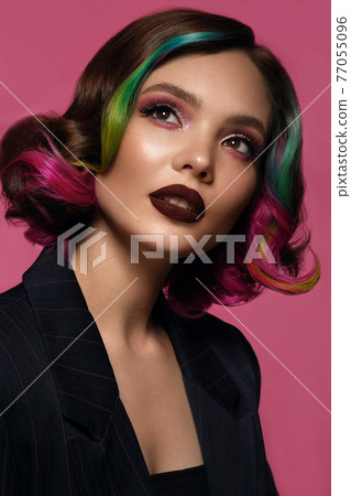 Beautiful woman with multi-colored hair and bright make up and hairstyle. 77055096