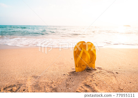 Yellow Flip flops on the beach Yellow Flip flops on the beach 77055111