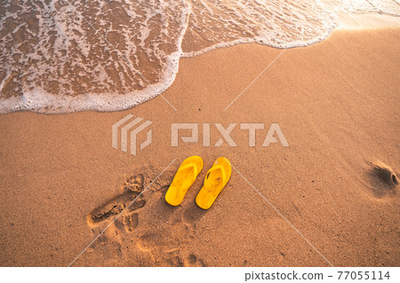 Yellow Flip flops on the beach Yellow Flip flops on the beach 77055114