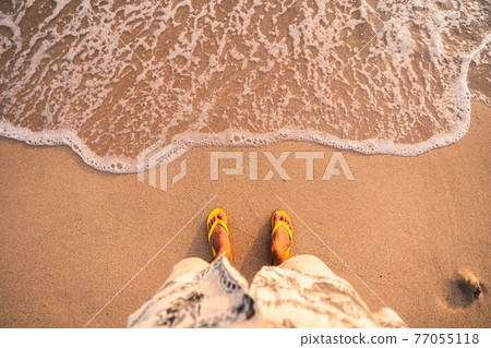 Yellow Flip flops on the beach Yellow Flip flops on the beach 77055118