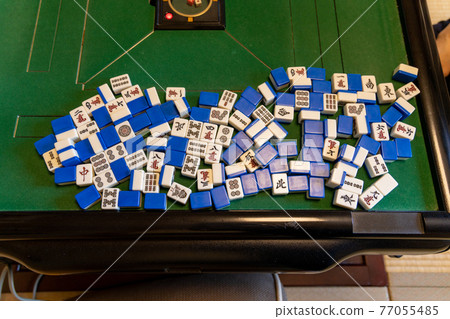 Mahjong tiles on the electric mahjong table 77055485