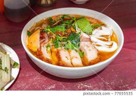 Bowl of Vietnam fish stock seafood noodle served with roasted pork Bowl of Vietnam fish stock seafood noodle served with roasted pork 77055535