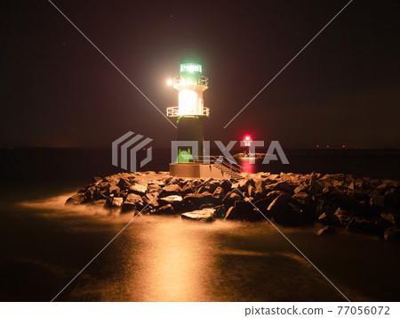 Westmole Leuchturm, shining signal light of breakwater at harbor Westmole Leuchturm, shining signal light of breakwater at harbor 77056072