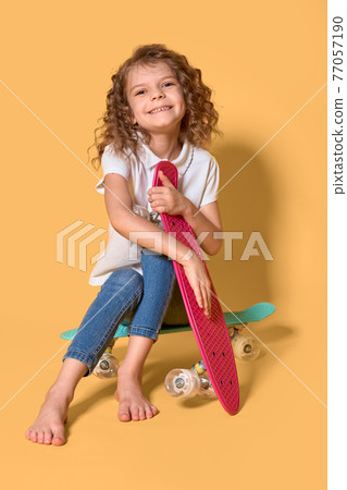 Active and happy Kid having fun with penny board, smiling face s 77057190