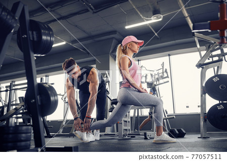 Side view of focused and motivated sporty young girl in sportswe 77057511