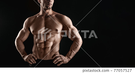 Unrecognizable Strong Athletic Sexy Muscular Man on Black Background Unrecognizable Strong Athletic Sexy Muscular Man on Black Background 77057527