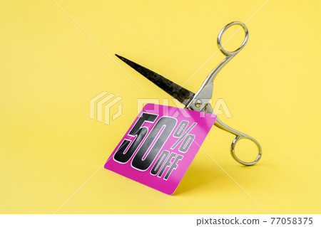 Metal scissors cutting the price tag Metal scissors cutting the price tag 77058375