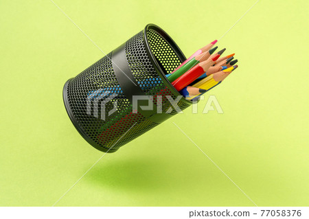 Colored pencils in a black mesh pen pot Colored pencils in a black mesh pen pot 77058376