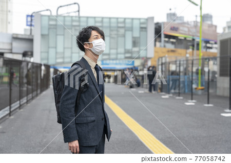 Portrait of a man in the early 30s wearing a mask 77058742