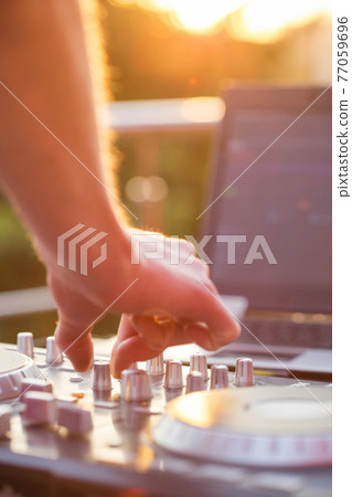 Dj mixing music outdoor. 77059696