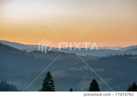 Beautiful early morning with fog between mountains Beautiful early morning with fog between mountains 77059762