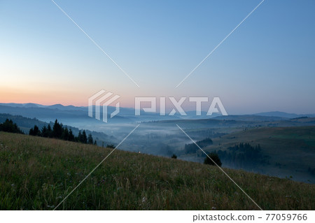 Beautiful early morning with fog between mountains Beautiful early morning with fog between mountains 77059766