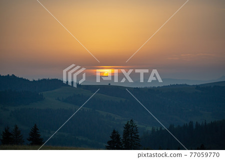 Mountain range on the background of the sunset Mountain range on the background of the sunset 77059770