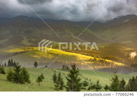 Storm clouds over mountains 77060246
