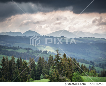 Mountains and storm clouds in the morning 77060256