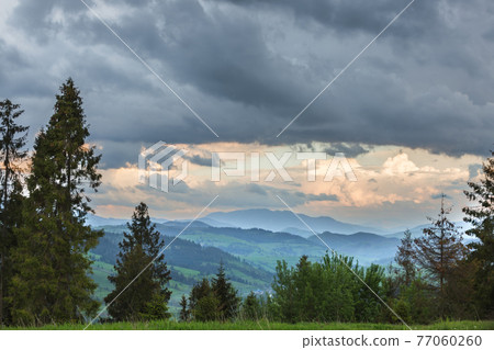 Storm clouds over mountains and the forest Storm clouds over mountains and the forest 77060260