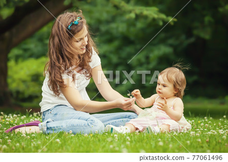 Mother and little daughter in the park 77061496