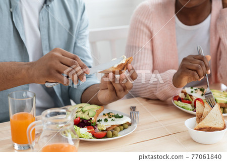 Tasty Meal. Closeup Shot Of Unrecognizable Black Man And Woman Eating Breakfast Tasty Meal. Closeup Shot Of Unrecognizable Black Man And Woman Eating Breakfast 77061840