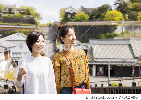 Young women and friends sightseeing in the castle town on a girls' trip [Kitsuki City] 77062496