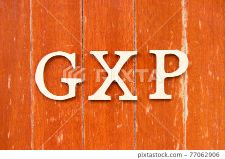 Alphabet letter in word GXP on old red color wood plate background 77062906